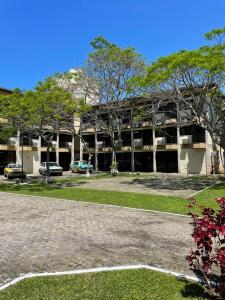 a large building with cars parked in front of it at Canto da Ilha in Florianópolis +15 photos