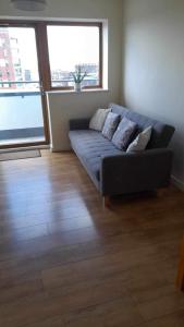 a living room with a couch and two large windows at One bedroom with Great city views in London
