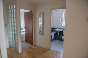a bathroom with a sink and a toilet and a mirror at Toothbrush Apartments - Central Ipswich St Peters St in Ipswich +44 photos
