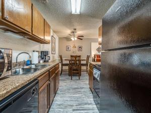 a kitchen with a sink and a counter top at OU Boomer, Pool & Gym, BBQ, Roku TVs, 100mb Internet, Washer & Dryer, just one mile to OU! in Norman