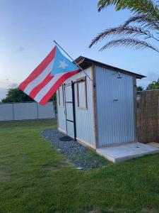 a smallshed with an american flag on top of it at El Camper RV with pool. in Aguadilla