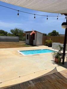 a swimming pool in a yard next to a house at El Camper RV with pool. in Aguadilla