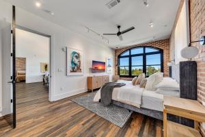 a bedroom with a large bed and a brick wall at Benz View Penthouse W Rooftop, Secure Parking in Atlanta