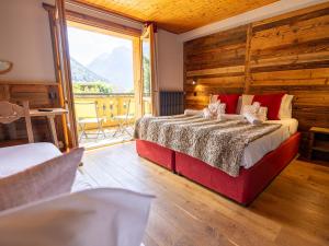 a bedroom with a large bed and a large window at L'Hermine Blanche in Morzine +47 photos