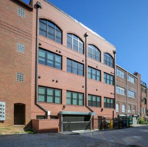 a red brick building with a lot of windows at Benz View Penthouse W Rooftop, Secure Parking in Atlanta