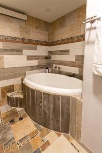 a bathroom with a bath tub in a room at Tranquility on White Tail Road in Deadwood