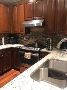 a kitchen with a sink and a stove top oven at Townhome Baptist South St JohnsTownCenter Beach in Jacksonville