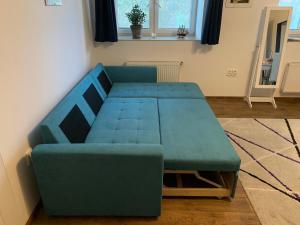 a blue couch sitting in a living room at U lesního muže in Střelice