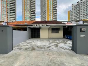 a house in the middle of some tall buildings at 5R4B 15Pax V KTV,KID'S POOL,POOL TABLE NEAR USM,LWE HOSPITAL,SPI ARENA in George Town