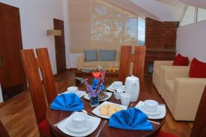 a living room with a table and a couch at Blue Meadows NuwaraEliya in Nuwara Eliya