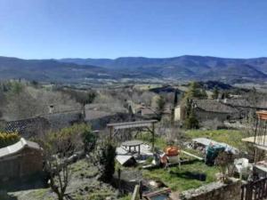 a view of a town with mountains in the background at Le Rubato in Rosans