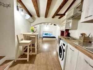 a kitchen with a table and a desk with a bed at RESIDENCE ZAR - 2 in Trieste