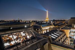 a view of a city with the eiffel tower at Hotel The Peninsula Paris in Paris