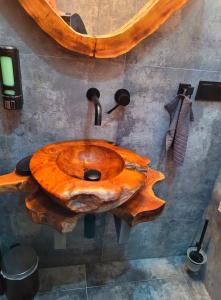 a wooden sink in a bathroom with a wooden table at Apartamenty Spokoloko Ostoja Beskidy ARKTYKAloft i Rapa Nui in Szczyrk
