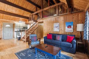 a living room with a blue couch and a table at Evergreen Chalet in Stowe