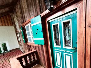 a wooden building with a blue door and a bench at Nusseckerl Eberloh in Halfing