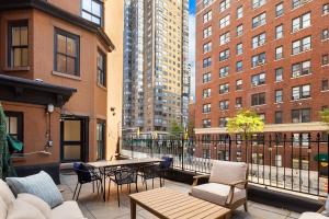 a patio with a table and chairs and buildings at Luxurious 5 BR Townhouse in New York