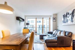 a living room with a table and a couch at Grand Canal 2 Bedroom Flat in Dublin