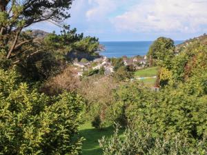a view of a house with the ocean in the background at Linden View in Ilfracombe