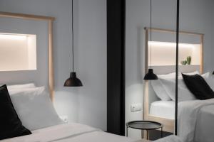 a bedroom with two beds and a mirror at Alyvia Central Apartment 1 in Ioannina