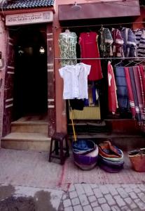 a clothing store with clothes hanging in front of it at Hotel salem leksor in Marrakesh