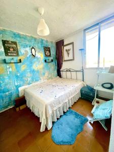 a bedroom with a bed and a blue rug at Room near the beach for 2 in Valencia