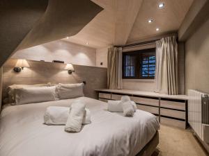 a bedroom with a large white bed with towels on it at Duplex 4 pers à Courchevel 1850 – Luxe et confort au pied des pistes - FR-1-631-175 in Courchevel