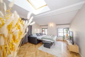 1 dormitorio con 1 cama y 1 sofá en una habitación en T2 cozy proche du centre avec canapé lit - 51Blatin, en Clermont-Ferrand