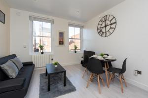 a living room with a couch and a table at Central Two Bed Flat Kings Lynn in Kings Lynn