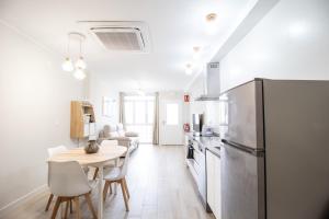a kitchen and dining room with a table and a refrigerator at Nautical Flats by Concept in Valencia +76 photos