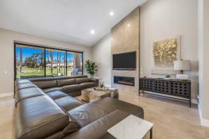 a large living room with a couch and a tv at Beautiful Condo with Mountain & Sunset Views! in Palm Desert