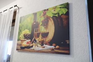 a picture of two glasses of wine on a wall at Holiday Home Rajf in Donji Koncovčak