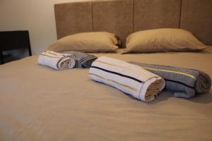 two towels on a bed with two pillows at Holiday Home Rajf in Donji Koncovčak +27 photos