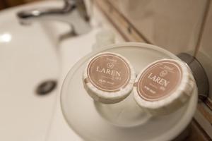 a close up of two containers of lager on a sink at Уютен апартамент с гледка в к-с Пирин Голф in Razlog +59 photos