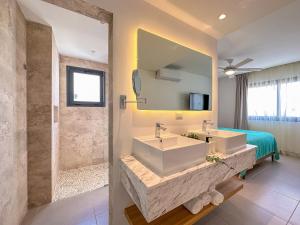 La salle de bains est pourvue de 2 lavabos et d'une douche. dans l'établissement Fantastic brand new beach condo, à Punta Cana