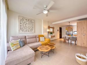 a living room with a couch and a table at Fantastic brand new beach condo in Punta Cana