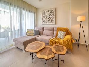 a living room with a couch and a table at Fantastic brand new beach condo in Punta Cana
