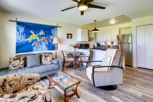a living room with a couch and a table at Kaunakakai Condo Walk to Beach, Community Pool! in Kaunakakai