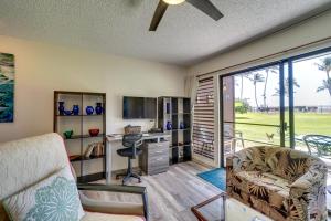 a living room with a couch and a desk with a chair at Kaunakakai Condo Walk to Beach, Community Pool! in Kaunakakai