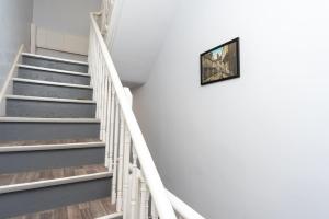 a staircase with a picture hanging on the wall at Central Two Bed Flat Kings Lynn in King's Lynn
