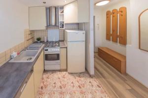 a kitchen with a white refrigerator and a sink at Urbannestgroup - City Center - Pereca 2 in Warsaw