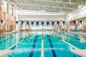 a large indoor swimming pool with blue water at Top of the Slopes in McHenry