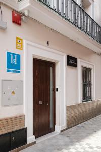 a door on the side of a building at Sevilla DosTorres in Seville