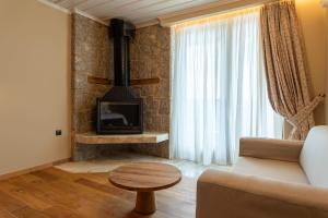 a living room with a couch and a fireplace at 5 Ραχες/5 Raches in Arachova