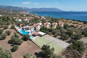 an aerial view of a villa with a tennis court at Kyma Hotel in Marathokampos