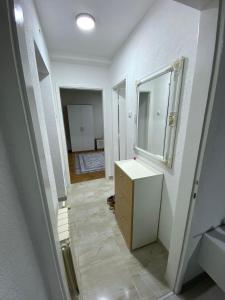 a bathroom with a sink and a mirror at Stan na dan Hasanovic in Tuzla