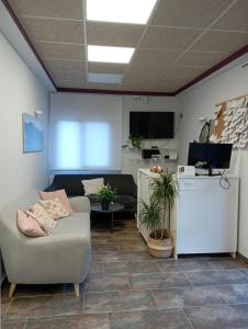 a living room with a couch and a refrigerator at Hotel Rural Rio Molinar in Ranera