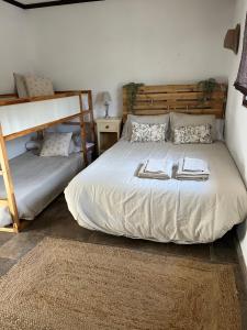 a bedroom with a bed and a bunk bed at La Casita de Campo in Córdoba
