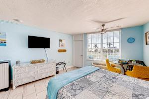 a bedroom with a bed and a flat screen tv at Right Along the Beach in Daytona Beach
