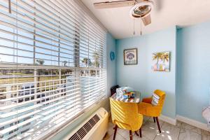 a room with a window with a bed and a table at Right Along the Beach in Daytona Beach